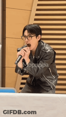 Man In Leather Jacket Singing Into Microphone GIF