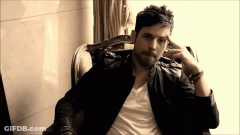 Man In Leather Jacket Sitting Hand On Head GIF