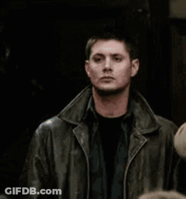 Man In Leather Jacket Standing Beside Another Man GIF