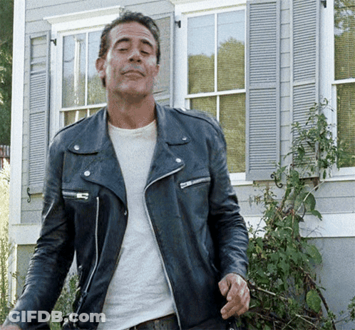 Man In Leather Jacket Standing In Front Of Building GIF