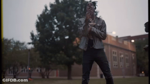 Man In Leather Jacket Standing In Front Of Building GIF