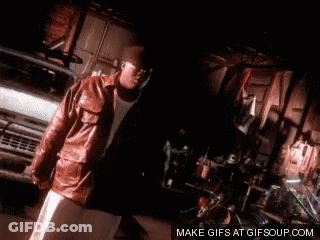 Man In Leather Jacket Standing Next To Truck GIF