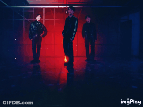 Man In Leather Jacket Standing Next To Two Men GIF