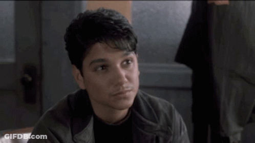 Man In Leather Jacket Talking To Another Man GIF