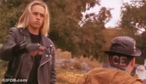 Man In Leather Jacket Talking To Man In Hat GIF