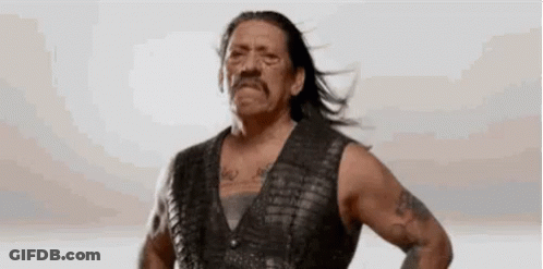 Man In Leather Vest With Hands On Hips Hair Blowing GIF