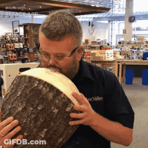 Man In Lee Valley Shirt Smelling Wood GIF
