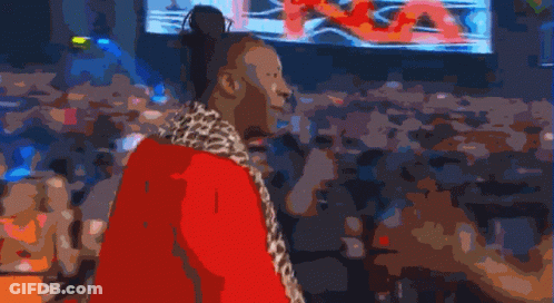 Man In Leopard Print Coat In Front Of Screen GIF