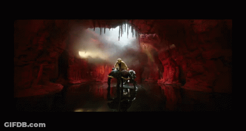 Man In Leopard Print Jacket In Cave GIF