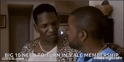 Man In Leopard Print Jacket Talking To Another Man In Living Room GIF