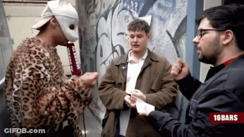 Man In Leopard Print Jacket Talking To Two Men With 16Bars Logo GIF