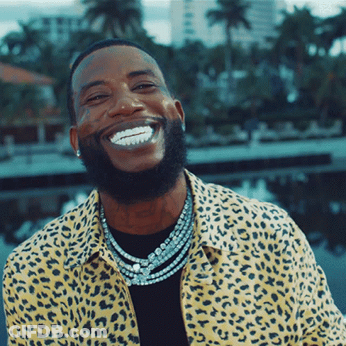 Man In Leopard Print Shirt And Necklaces Smiling GIF