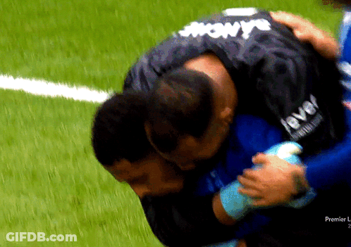 Man In Level Jersey Hugging Another On Soccer Field GIF