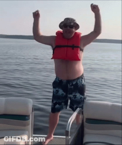 Man In Life Jacket On Boat Arms In Air GIF