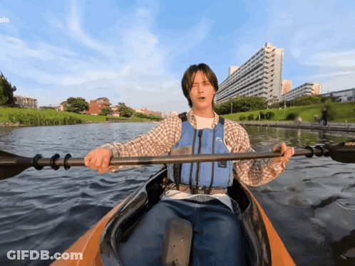 Man In Life Vest Paddling Kayak On Lake GIF