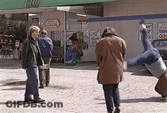 Man In Little Coat Standing With Arms Out GIF