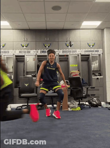 Man In Locker Room Wearing 2Amw Shirt GIF