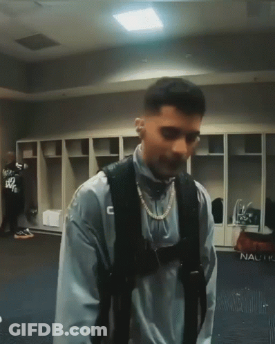 Man In Locker Room With C Sweatshirt GIF