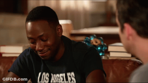 Man In Los Angeles T-Shirt Smiling On Couch GIF