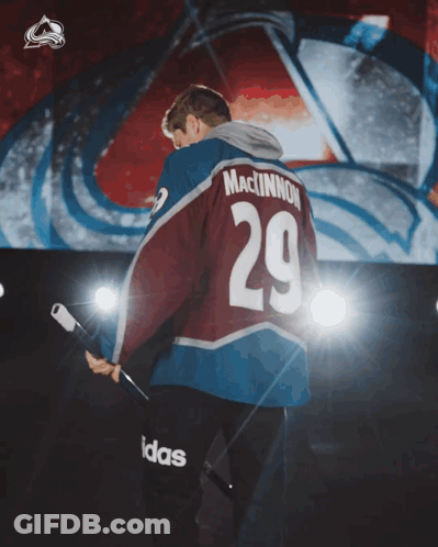 Man In MacKinnon 29 Jersey Holding Hockey Stick GIF