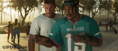 Man In Manatees Jersey Looking At Cell Phone GIF