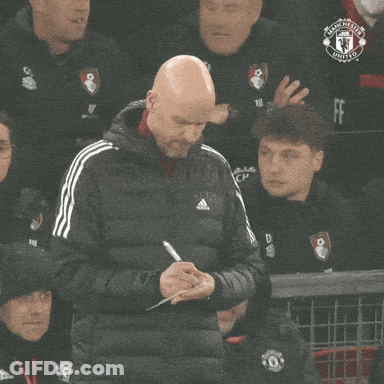 Man In Manchester United Jacket Taking Notes GIF