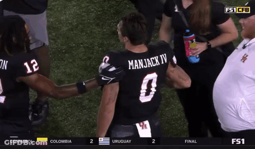 Man In Manjack IV Jersey Talking To Another Man GIF
