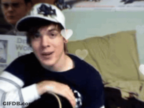 Man In Maple Leafs Hat Looking At Camera GIF