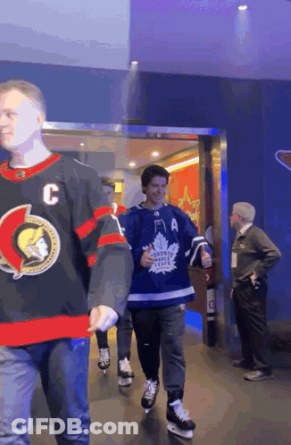 Man In Maple Leafs Jersey Walking GIF