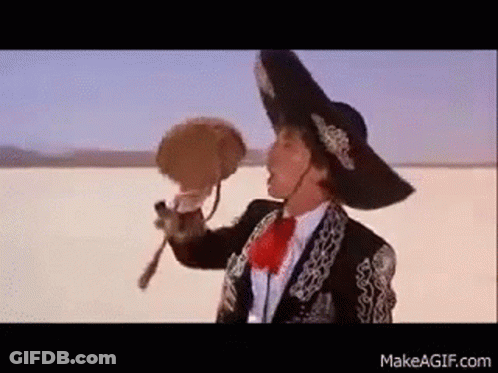 Man In Mariachi Outfit Holding Fan GIF