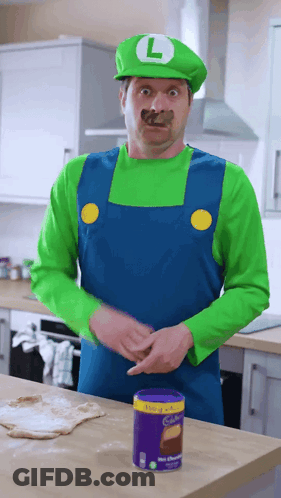 Man In Mario Costume Standing Near Cadbury Chocolate GIF