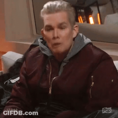Man In Maroon Jacket Sitting On Couch GIF