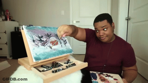 Man In Maroon Shirt Painting On Easel GIF