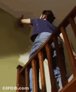 Man In Maroon Shirt Painting On Easel GIF