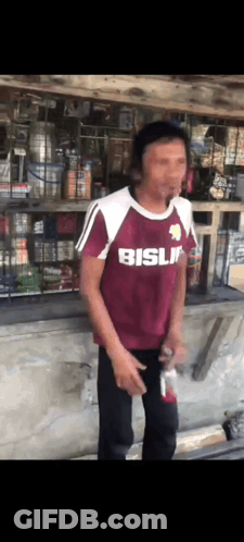 Man In Maroon Shirt Saying Bisli In Front Of Store GIF