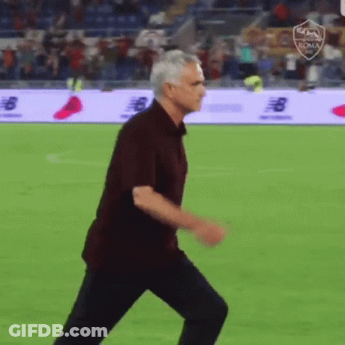 Man In Maroon Shirt Walking On Soccer Field GIF