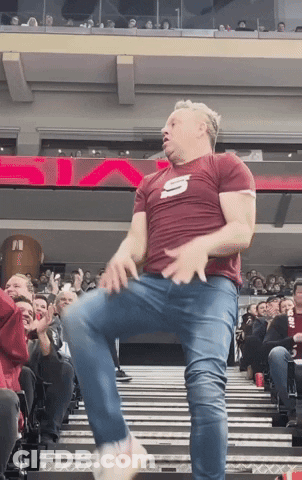 Man In Maroon Shirt With Letter S Dancing GIF