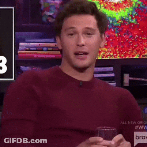 Man In Maroon Sweater Holding Glass Of Wine GIF
