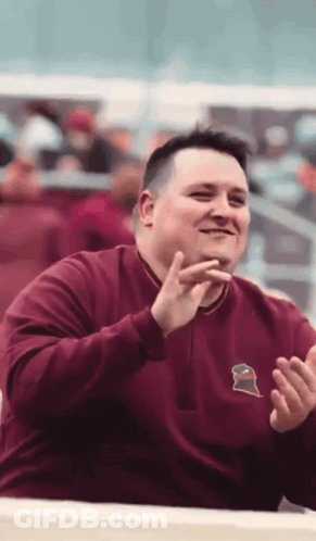 Man In Maroon Sweatshirt With Gator GIF