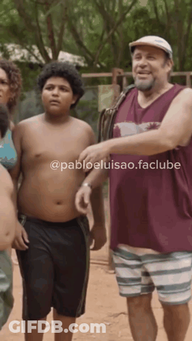 Man In Maroon Tank Top Next To Boy In Striped Shorts GIF