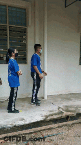 Man In Mask And Girl In Blue Shirt Saying A GIF