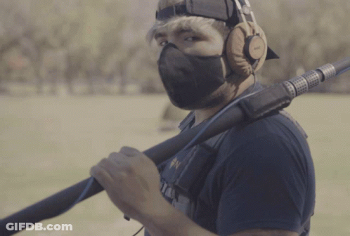 Man In Mask And Headphones Holding Microphone GIF