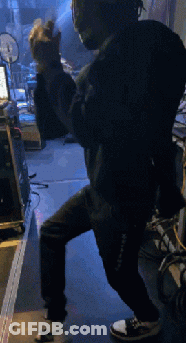Man In Mask And Headphones Standing On One Leg GIF