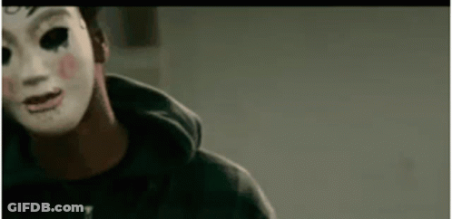 Man In Mask And Hoodie Looking At Camera GIF