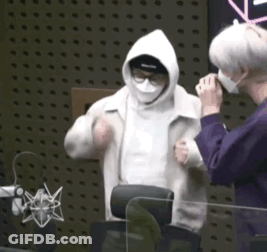 Man In Mask And Hoodie Standing Next To Another Man GIF