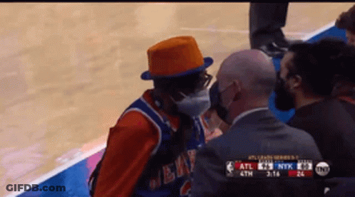 Man In Mask And Orange Hat Talking To Referee GIF