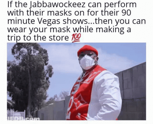 Man In Mask And Red Hat Standing In Front Of Tree GIF
