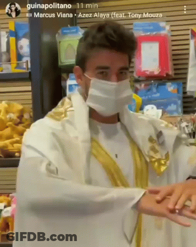 Man In Mask And Robe Standing In Store GIF