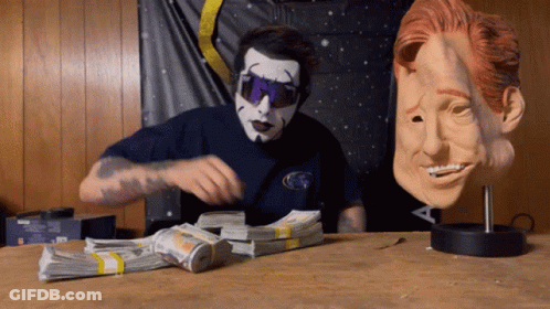 Man In Mask And Sunglasses Next To Money GIF