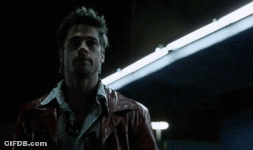 Man In Mask And Sunglasses Walking Through Hallway GIF